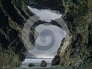 The view from the inside of a cave to the sea