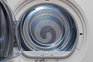 View inside of a clothes dryer, close up. Empty tumble dryer