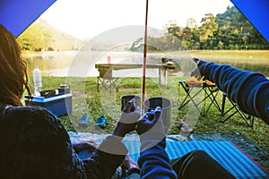 The view inside the couple`s tent is sitting in the morning coffee. Couple travel camping tents, Travel nature. Travel relax,