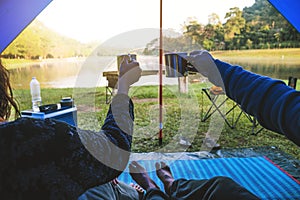 The view inside the couple`s tent is sitting in the morning coffee. Couple travel camping tents, Travel nature. Travel relax,