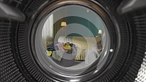 View from inside the empty washing machine with an opened door into the living room. Slow motion HDR BT2020 HLG Material