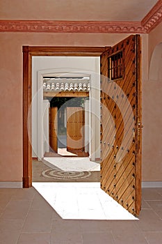 View from inside a house, looking through two open doorways.