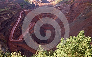 View inside the iron oxid quarry with trails on slopes photo