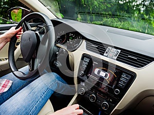 Wide angle view inside modern luxury car with female woman driving inside making