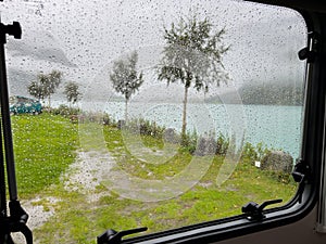 View from inside a motorhome camper on a rainy day in the Briksdal Glacier Valley, Norway