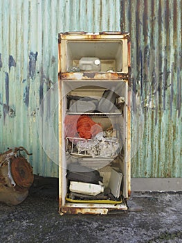 View of the inside old rusty broken fridge. Martinique, French West Indies. Tropical culture