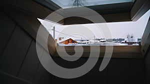 View from inside through the open dormer window of the winter village