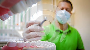 View from inside of mouth of doctor holding dental drill