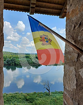 View from inside the Soroca fortress of the flag of the Republic of Moldova fluttering in the wind. In the background you can see