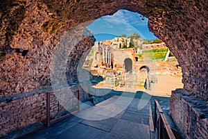 View from inside the stone arch of ruine of Greco-Roman theater, Sicily, Italy