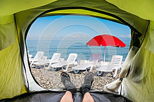 View from inside a tent on the sun loungers on a beach