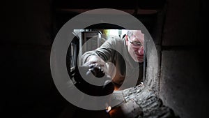 View from inside wood burning stove to stoker who lights fire.