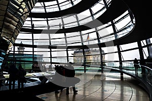View through the interior of the glass dome at the top of the Reichstag, a historic building which houses the Bundestag, the lower