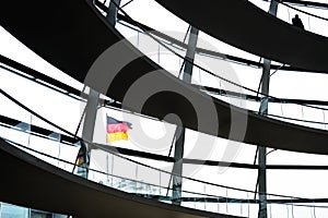 View through the interior of the glass dome at the top of the Reichstag, a historic building which houses the Bundestag, the lower