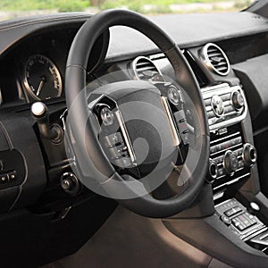 View of the interior of a modern automobile showing the dashboard. Black interior