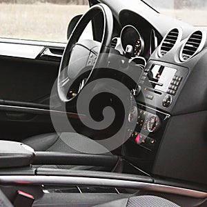 View of the interior of a modern automobile showing the dashboard. Black interior