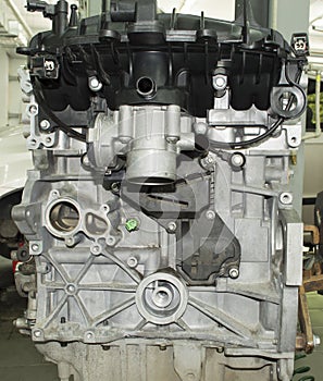 View of the internal combustion engine from the side of the plastic intake manifold