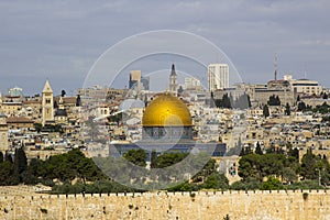 A view of the Islamic Dome of the Rock mosque from the ancient Mount of Olives situated to the East of the old city of Jerusalem photo