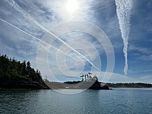 View of an island with blue skies and clouds along the Central Coast of British Columbia photo