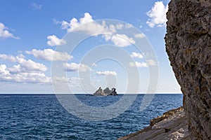 View of  island called Sveta Nedelja St. Sunday near Petrovac, Montenegro and blue sky with white fluffy clouds