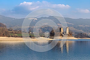 View of the island of Ogoz, Ile d'Ogoz, on Lake Gruyere in Switzerland. There are the ruins of a castle and a