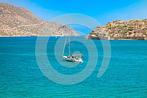 View of the island of Spinalonga with calm sea. gulf of Elounda, Crete, Greece.