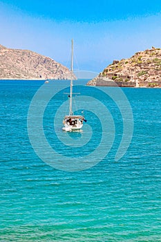 View of the island of Spinalonga with calm sea. gulf of Elounda, Crete, Greece.