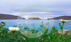 View of the island of Spinalonga with calm sea. Here were isolated lepers, humans with the Hansen`s desease, gulf of Elounda.