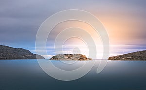 View of the island of Spinalonga with calm sea. Here were isolated lepers, humans with the Hansen`s desease, gulf of Elounda.