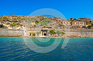 View of the island of Spinalonga with calm sea. Here were lepers, humans with the Hansen`s desease, gulf of Elounda.