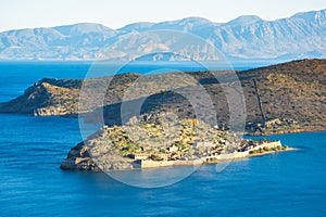 View of the island of Spinalonga with calm sea. Here were lepers, humans with the Hansen`s desease, gulf of Elounda.