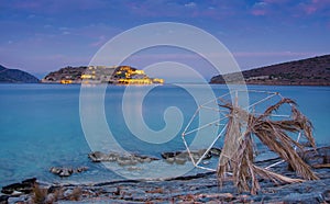 View of the island of Spinalonga at night with nice clouds and calm sea. Here were lepers.