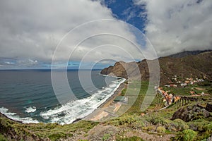 View of the island of Tenerife from Santa Catalina beach. Huge concrete piers for davit and the ruins of the old Hermigua port in