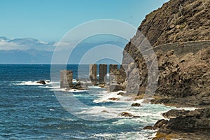 View of the island of Tenerife from Santa Catalina beach. Huge concrete piers for davit and the ruins of the old Hermigua port. La