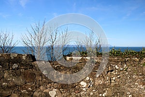 View of Isle of Arran in Scotland Over an Ancient Stone Wall