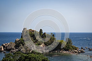 View of Isola Bella island in Taormina, Sicily, Beach with tourists surrounded by the Sea