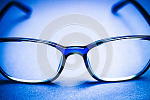 View on isolated blue eye glasses on blan background photo