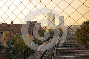 View of Istanbul from the bridge over the railway through the mesh fence into the sunset, Turkey