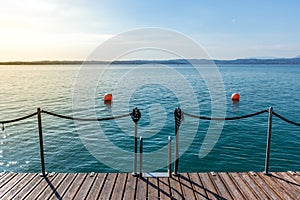 Wooden jetty on peacefull Garda Lake, Sirmione photo