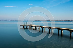 Wooden jetty on peacefull Garda Lake, Sirmione photo