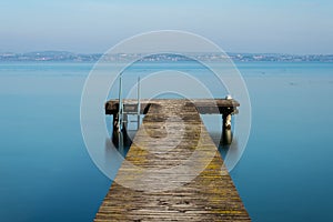 Wooden jetty on peacefull Garda Lake, Sirmione photo