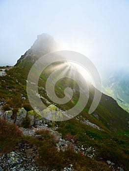 View on jagged mountain of Zillertal alps on a foggy summer day