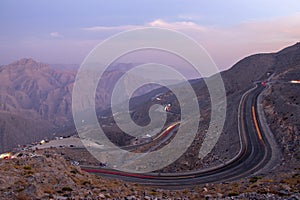 View from Jebael Jais mountain of Ras Al Khaimah emirate in the evening. United Arab Emirates, Light trails from the car