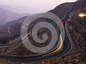 View from Jebael Jais mountain of Ras Al Khaimah emirate in the evening. United Arab Emirates, Light trails from the car