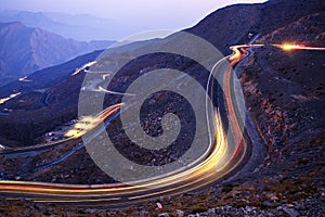 View from Jebael Jais mountain of Ras Al Khaimah emirate in the evening. United Arab Emirates, Light trails from the car