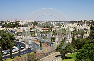 View of Jerusalem, Israel. Palm trees, cars, modern tram