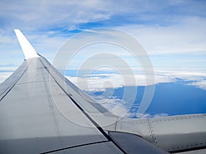 View of jet plane wing on the background of thick clouds