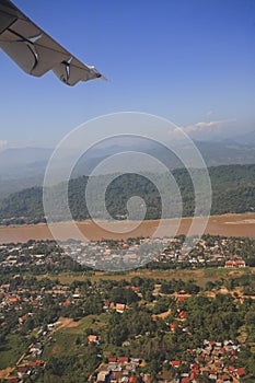 View of jet plane wing with city view