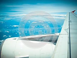 View of jet plane wing with cloud