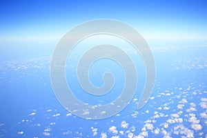 View of jet plane wing with cloud patterns